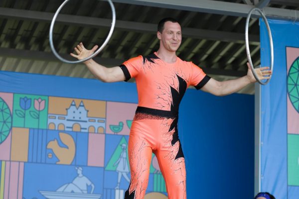 Acrobat performing a thrilling balancing act with hoops on stage.