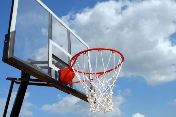 pexels-photo-264258-264258 A basketball hoop and backboard set against a clear blue sky, capturing the essence of outdoor sports.